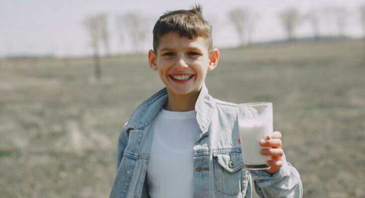 Happy boy with glass of milk