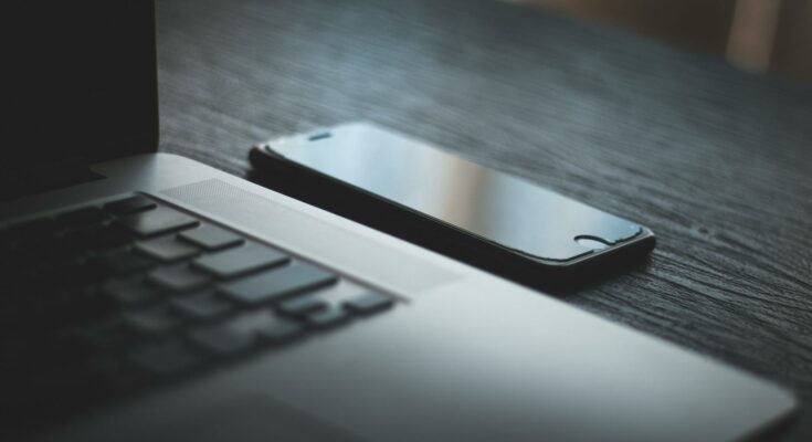iPhone beside laptop computer