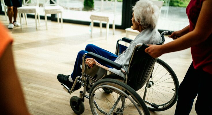 Senior sitting in a wheelchair in a nursing home