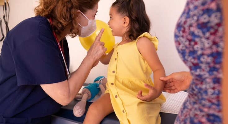 Nurse talking to a little girl at a pediatricians office