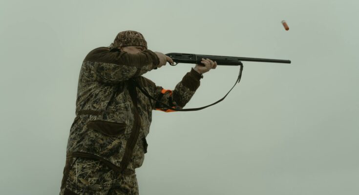 Man firing his shotgun