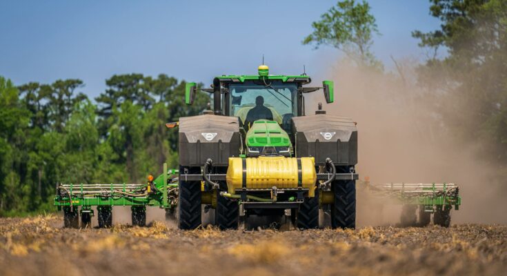 A tractor with a seeder on a cropland