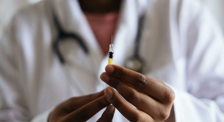Doctor holding injection