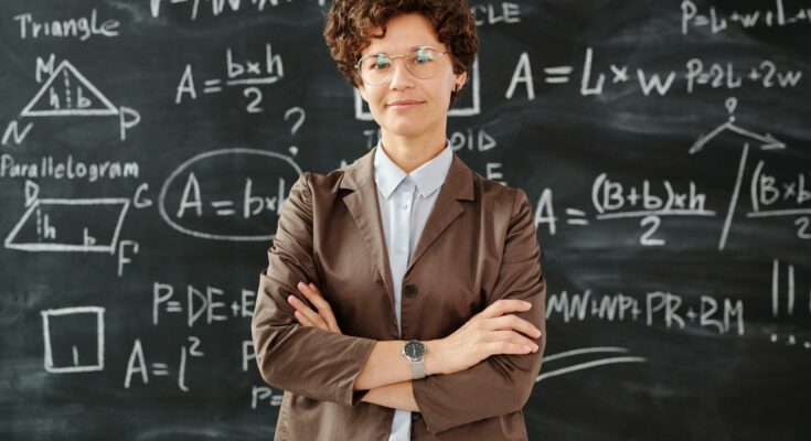 Teacher standing in front of blackboard