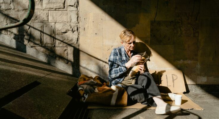 Woman sitting on the sidewalk