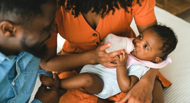 Woman feeding a baby
