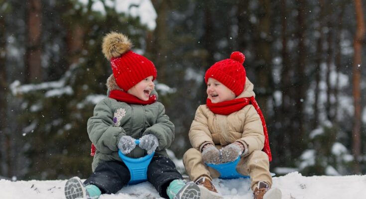Children sitting on sleds