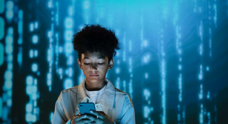 A boy using a mobile phone
