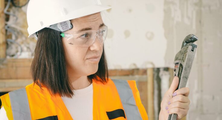 Handywoman holding a plumbers wrench