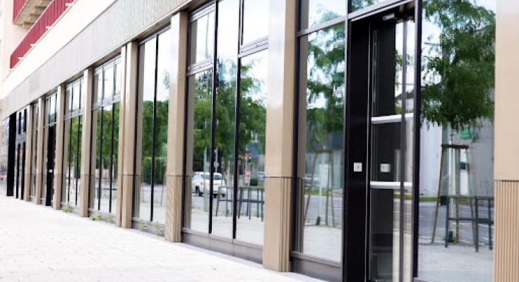 A modern glass facade of a ground-floor commercial building