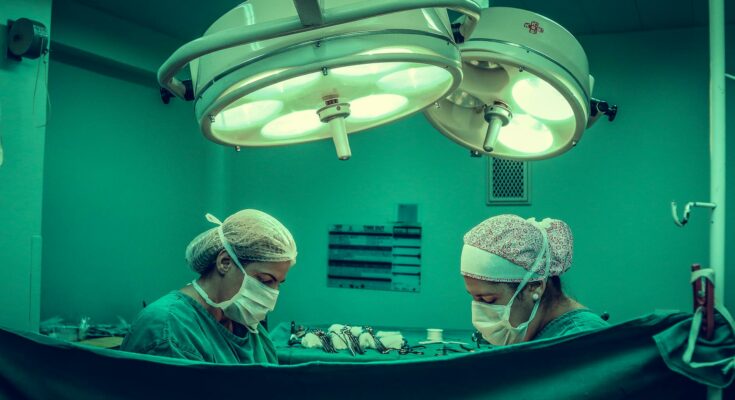Two persons doing surgery