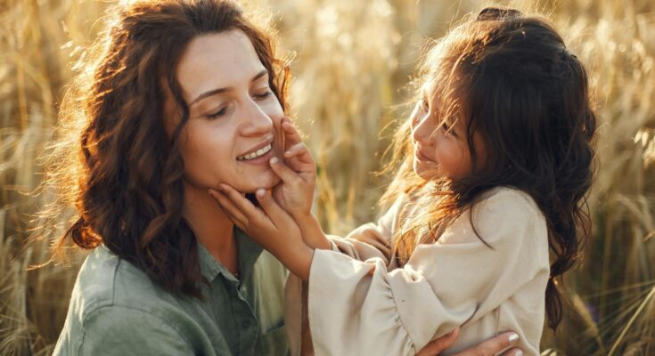 Little girl touching mother face