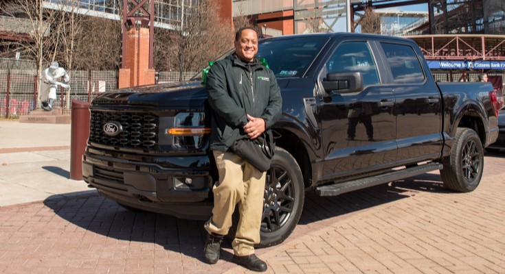Kym Hunter stands in front of new truck