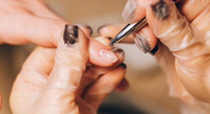 Nail stylist removing cuticles