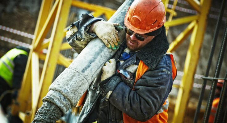 Man carrying gray pipe