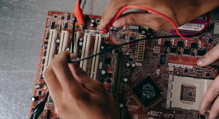 Close up photo of motherboard being fixed