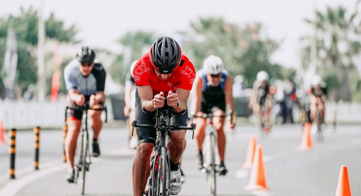 Cyclists riding bikes on road during race