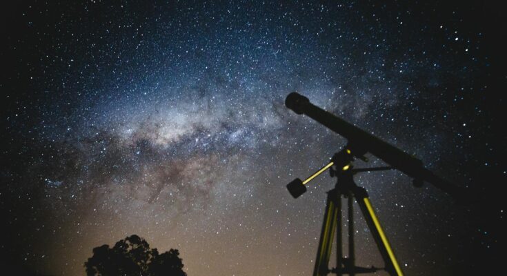 Telescope under blue and black sky