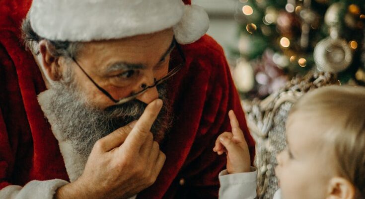 Santa Claus standing beside toddler