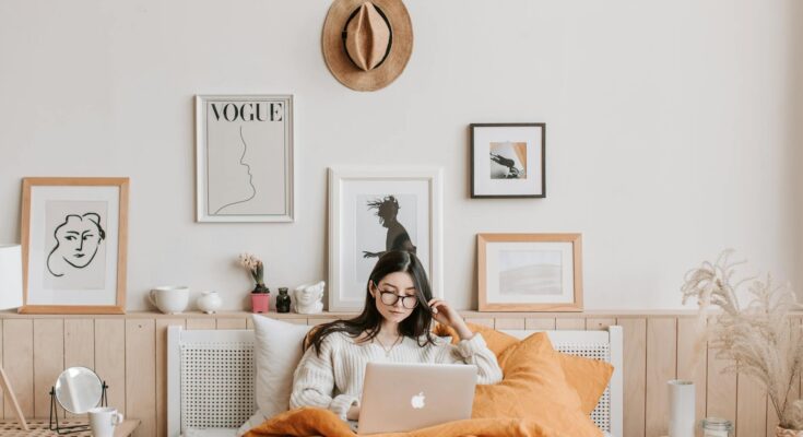 Woman using laptop in bed