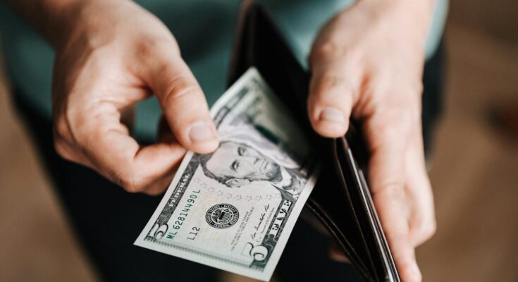 Man holding wallet with money