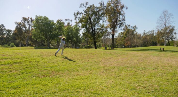 A person running on green grass field