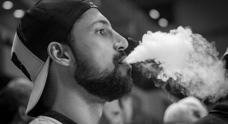 Man with smoke on mouth