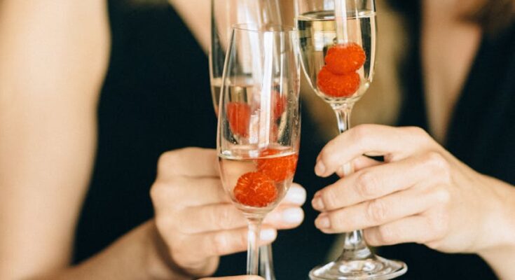 woman holding glasses of champagne