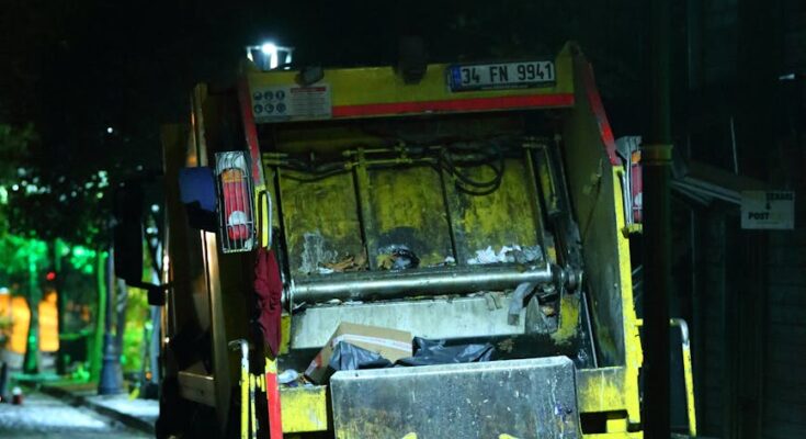 Garbage truck at the side of the road