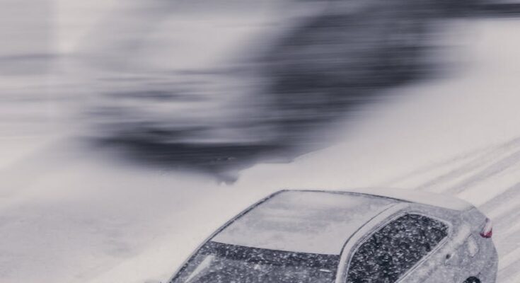 Carr on road during snowstorm