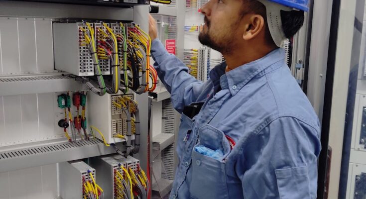 Electrician working with cables