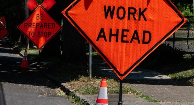 Roadwork warning sign on street