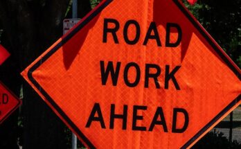 Roadwork warning sign on street