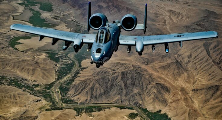 Jet fighter flying above mountains