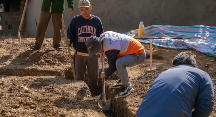 community volunteers digging a trench