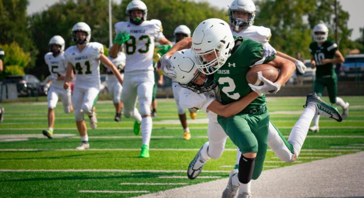 intense high school football game action shot