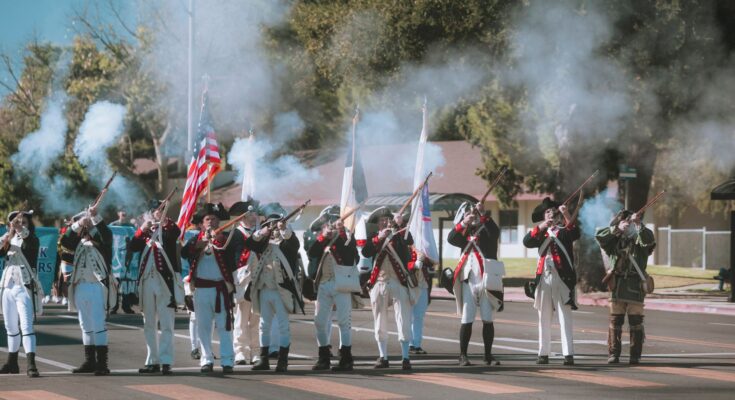 historical reenactment parade with musket firing