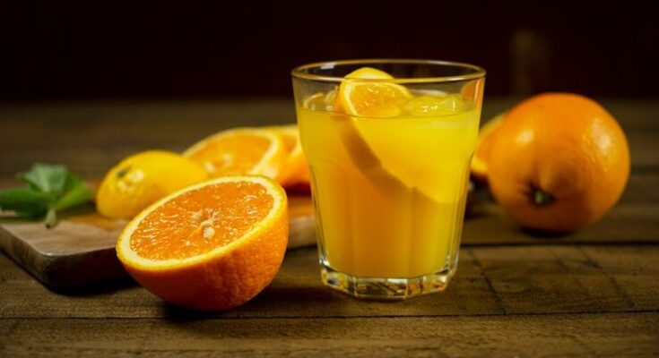 orange juice in clear drinking glass