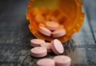 white medication pill on orange plastic container