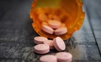 white medication pill on orange plastic container