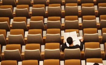 person reading in empty lecture hall