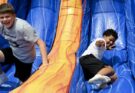 kids on inflatable slide