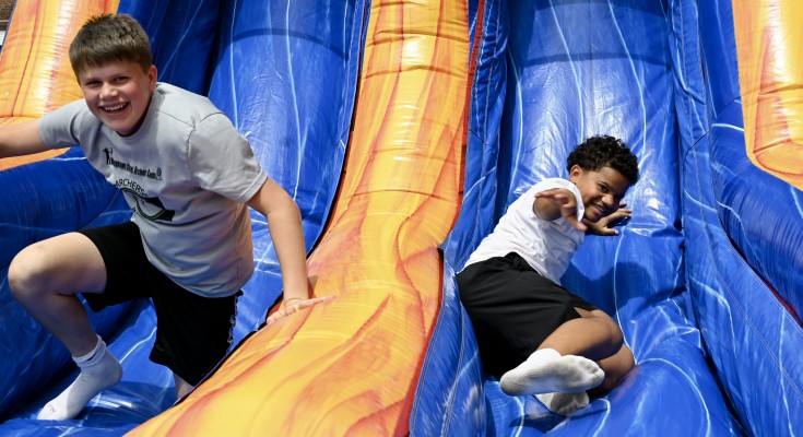 kids on inflatable slide