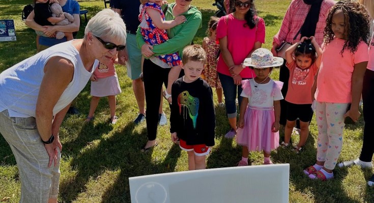 Sen. Comitta reading the StoryWalk at Library Card Sign Up Fest