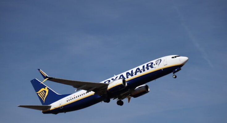Ryanair airplane ascending into a clear blue sky