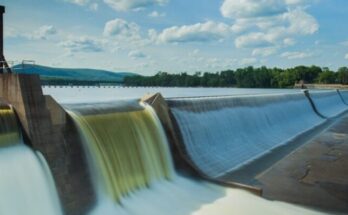 water dam under white and blue skies