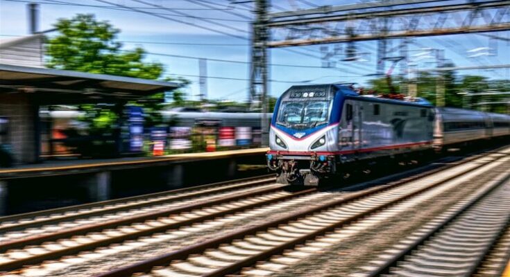 a train traveling down train tracks next to a station