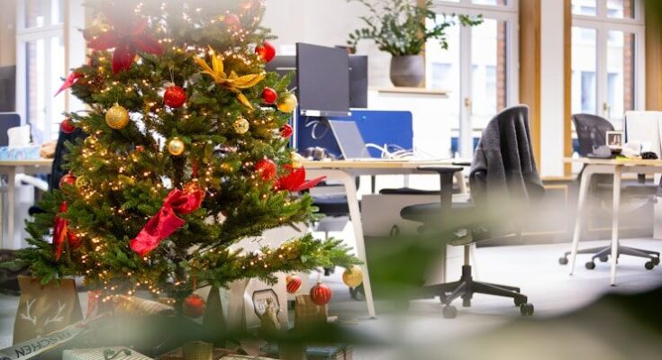 A decorated christmas tree in an office cubicle
