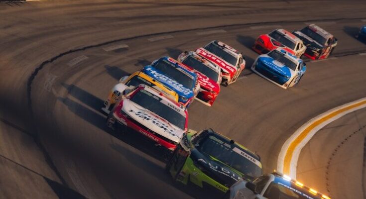 Race cars speeding around a sharp turn on a track