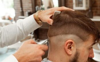 man in white dress shirt cutting hair of man